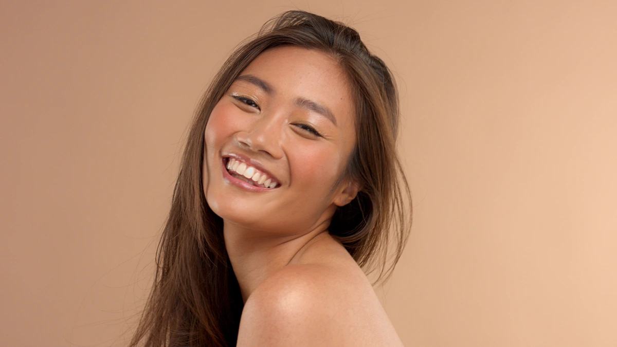 Thai asian model with natural makeup on beige background